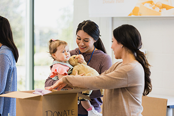 Mom and baby donating baby supplies