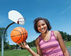 Teen playing basketball