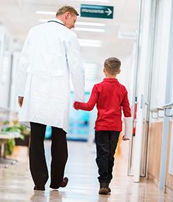 Doctor walking with child patient